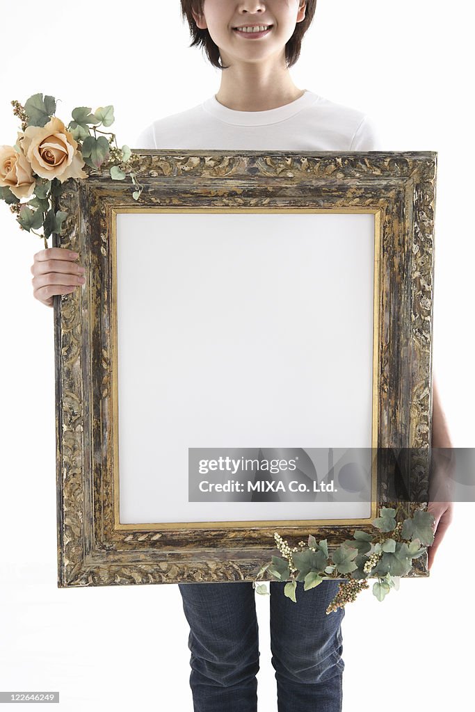 Woman holding picture frame