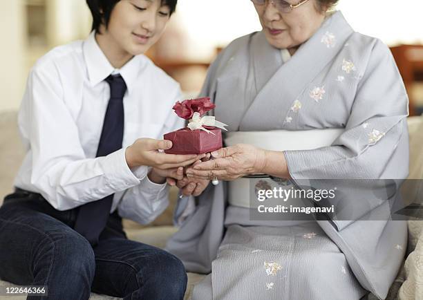 Boy giving a gift to his grandmother