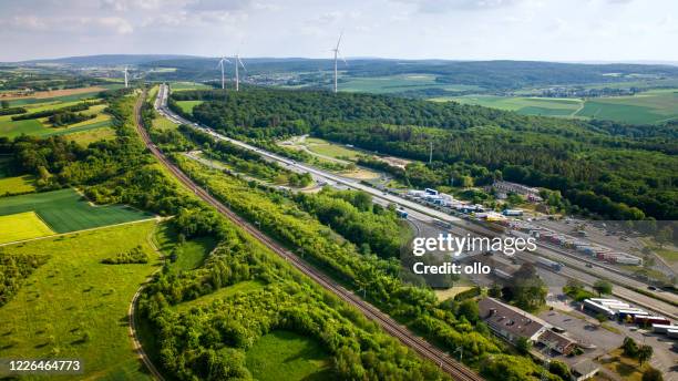 german highway and highspeed train railroad track - aerial view - rail transportation freight stock pictures, royalty-free photos & images