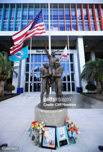 Flowers and plaques from former NFL player Jim Jensen and Carlos A. Gimenez, Mayor of Miami-Dade county, are displayed next to the “A Perfect Moment...
