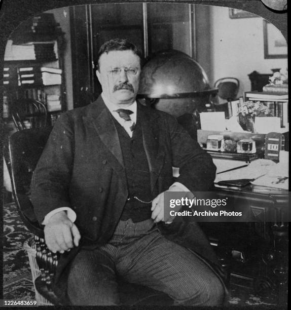 President Theodore Roosevelt at his desk in the White House in Washington, DC, circa 1905.