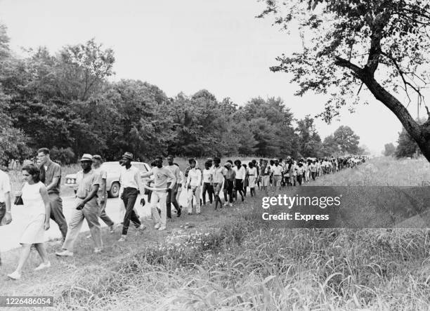 The Freedom March moves along the verge of US Highway 51 in Mississippi, under the surveillance of police patrols, June 1966. The march, from Memphis...