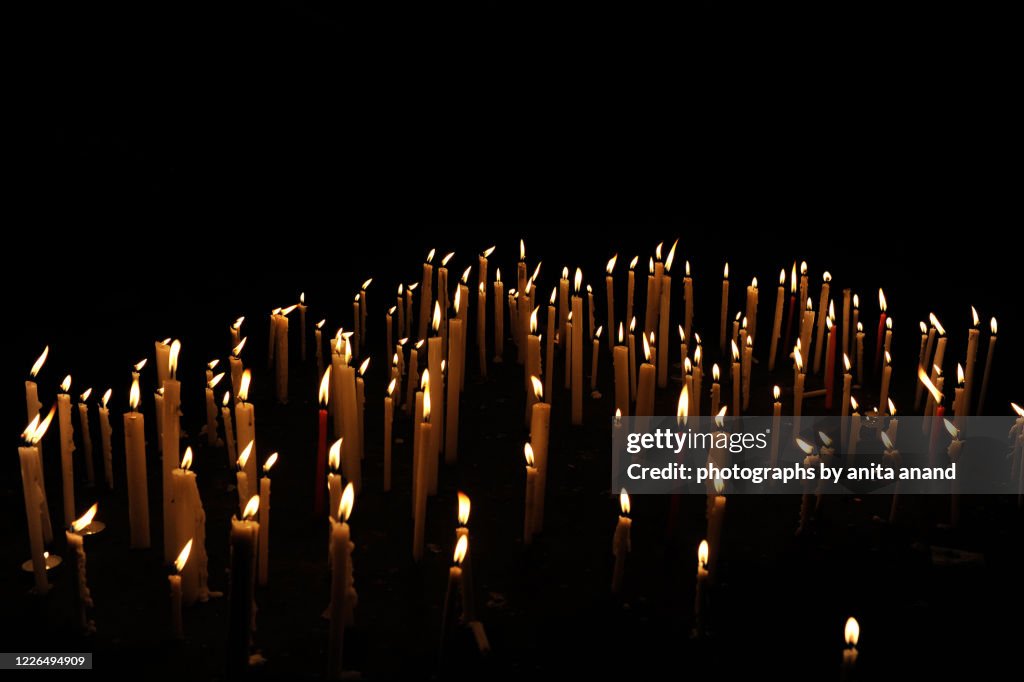 Lit Candles burning in the night