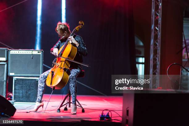 woman playing cello on the stage - acoustic music stock pictures, royalty-free photos & images