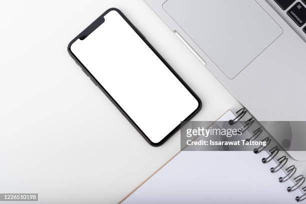 top view of smartphone mock up screen on the white table with copy space. - table top imagens e fotografias de stock