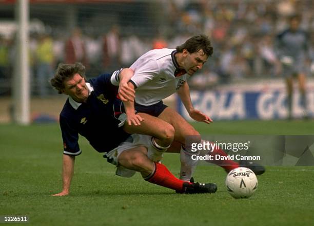 Bryan Robson of England is tackled during the Rous Cup match against Scotland at Wembley Stadium in England. England won the match 1-0. \ Mandatory...