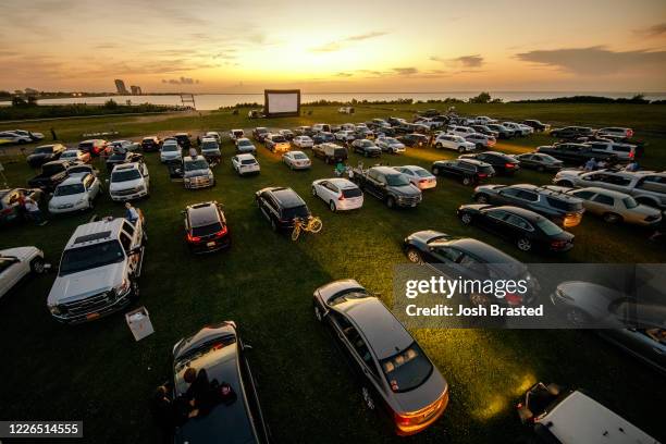 Attendees arrive to watch the movie "Grease" at a pop-up drive-in theatre at Bucktown Marina Park on May 22, 2020 in Metairie, Louisiana. With indoor...