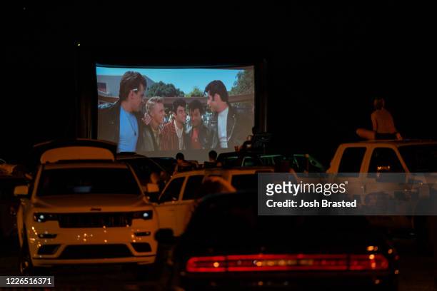 Guests attend a screening of the movie "Grease" at a pop-up drive-in theatre at Bucktown Marina Park on May 22, 2020 in Metairie, Louisiana. With...