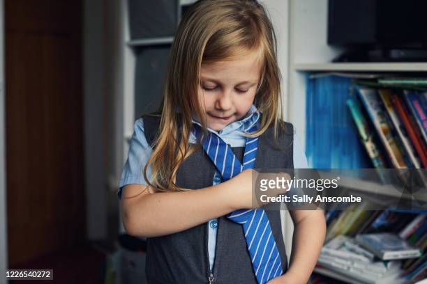 school child getting ready for school - school uniforms stock-fotos und bilder