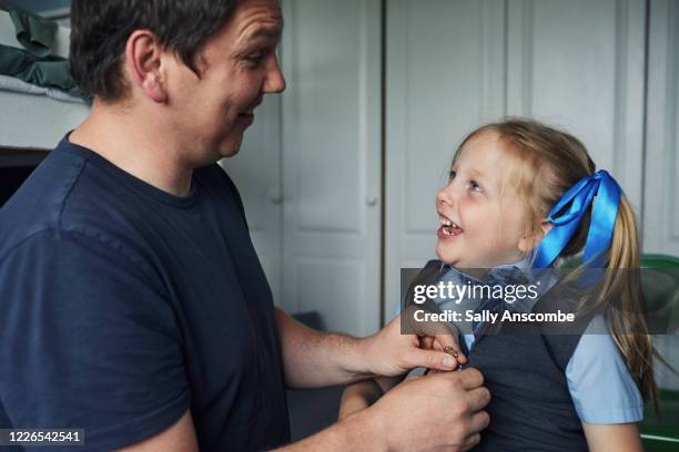 school child getting ready for school - child getting dressed stock-fotos und bilder