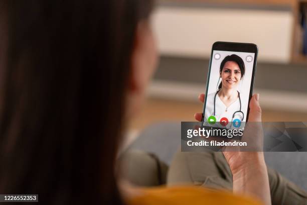 video call with doctor - mobile health stock pictures, royalty-free photos & images