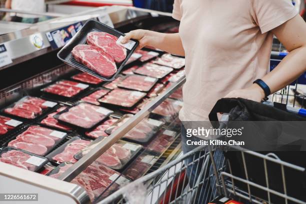 woman shopping at meat section - meat fotografías e imágenes de stock