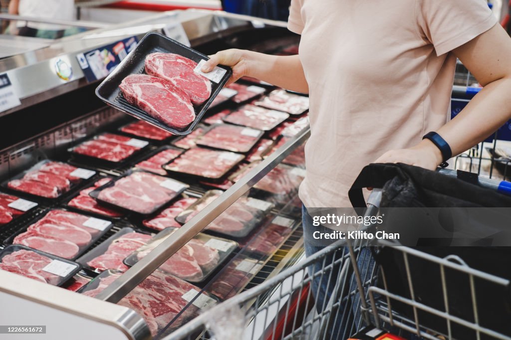 Woman shopping at meat section