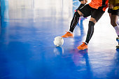 Indoor soccer sports hall. Football futsal player, ball, futsal floor. Sports background.