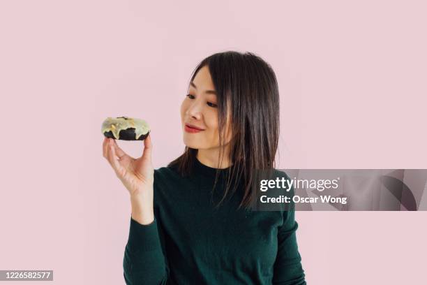 indulging in desserts - woman holding cake stock-fotos und bilder