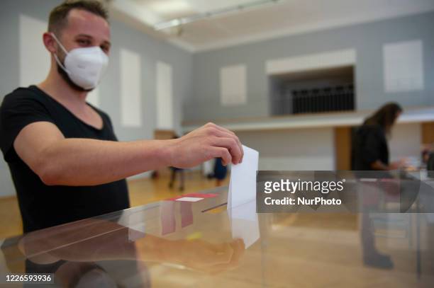 Voter casts his ballot during the second round of presidential elections on July 12, 2020 in Warsaw, Poland. Poles are voting in the presidential...