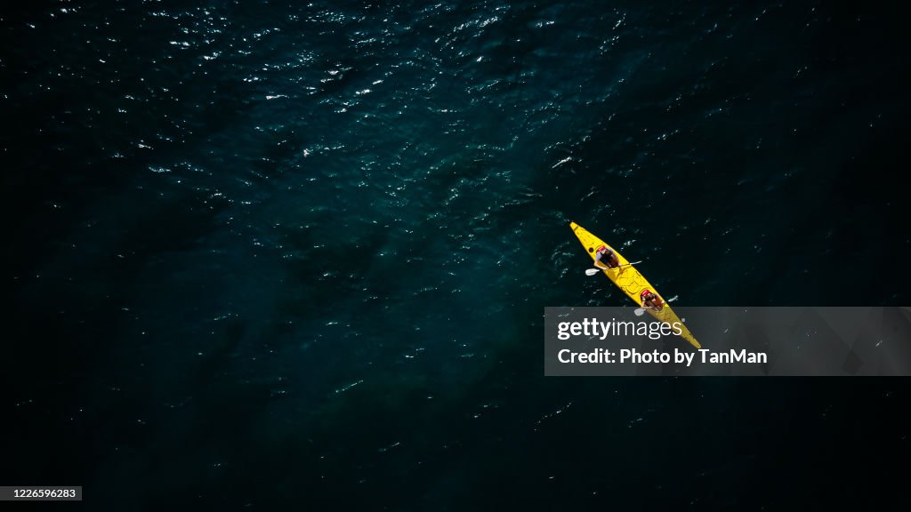 Tandem Yellow Kayak in dark green waters of Wanaka