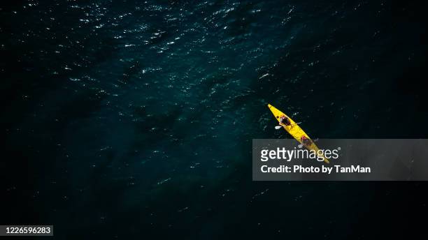 tandem yellow kayak in dark green waters of wanaka - kayaking aerial stock pictures, royalty-free photos & images
