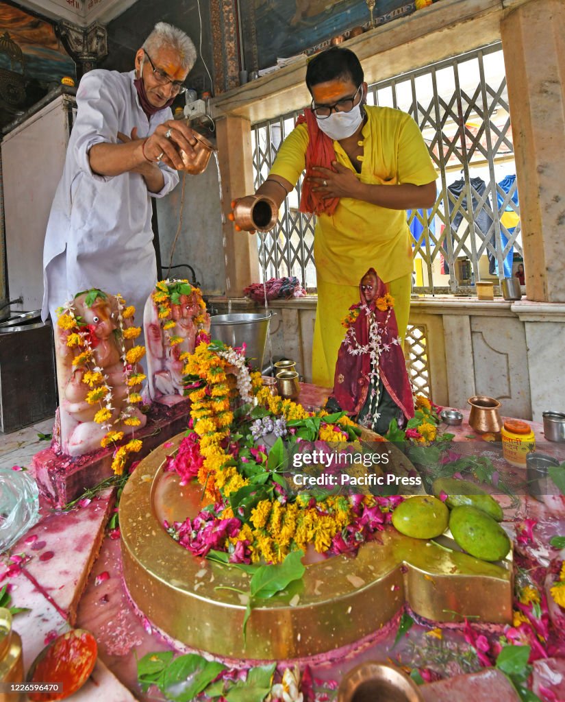Hindu devotees perform 'Abhishek' of Lord Shiva on the first...