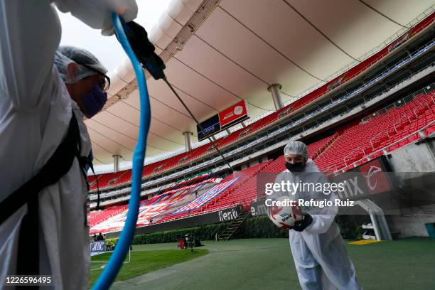 Staff members of the Akron Stadium sanitize the balls before the match between Atlas and Tigres UANL as part of the friendship tournament Copa GNP...