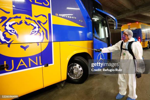 Staff member of the Akron Stadium sanitizes a bus before the match between Atlas and Tigres UANL as part of the friendship tournament Copa GNP por...