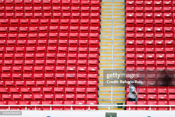 Staff member of the Akron Stadium cleans the stands before the match between Atlas and Tigres UANL as part of the friendship tournament Copa GNP por...