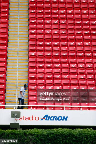 Staff member of the Akron Stadium cleans the stands before the match between Atlas and Tigres UANL as part of the friendship tournament Copa GNP por...