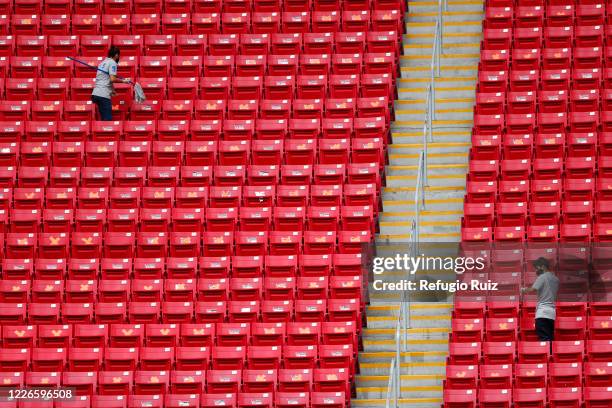 Staff members of the Akron Stadium clean the stands before the match between Atlas and Tigres UANL as part of the friendship tournament Copa GNP por...