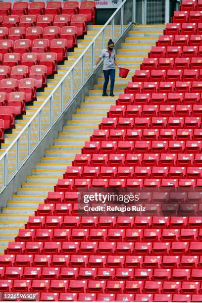 Staff member of the Akron Stadium cleans the stands before the match between Atlas and Tigres UANL as part of the friendship tournament Copa GNP por...