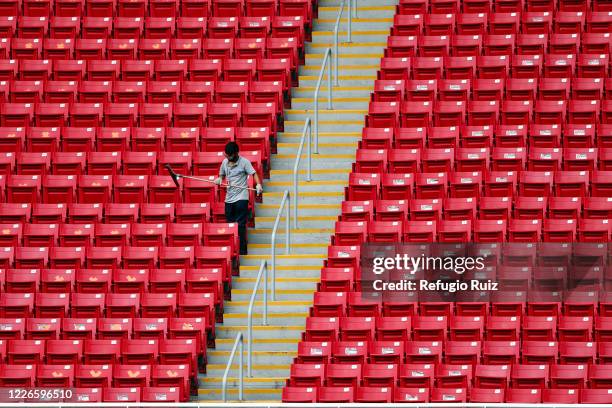 Staff member of the Akron Stadium cleans the stands before the match between Atlas and Tigres UANL as part of the friendship tournament Copa GNP por...