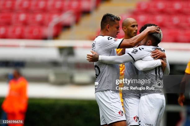 Luciano Acosta of Atlas celebrates with his teammates after scoring the first goal of his team during the match between Atlas and Tigres UANL as part...