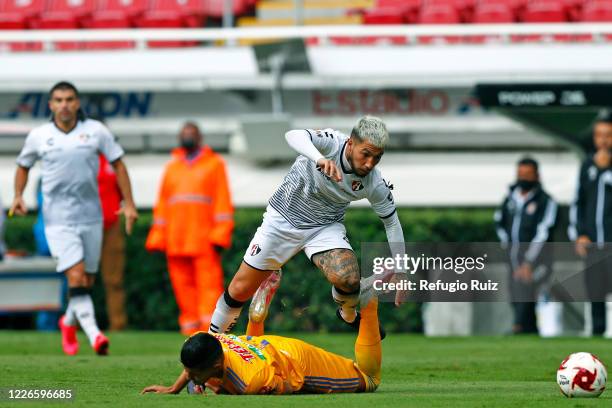 Luciano Acosta of Atlas fights for the ball with Hugo Ayala of Tigres during the match between Atlas and Tigres UANL as part of the friendship...