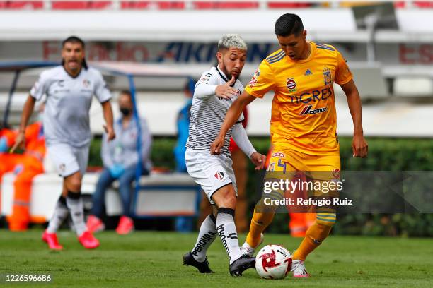 Luciano Acosta of Atlas fights for the ball with Hugo Ayala of Tigres during the match between Atlas and Tigres UANL as part of the friendship...