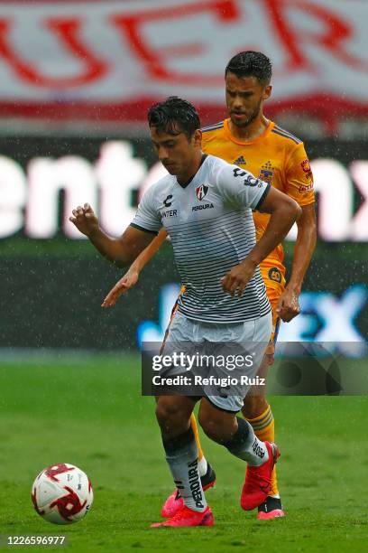 Jairo Torres of Atlas fights for the ball with Diego Reyes of Tigres during the match between Atlas and Tigres UANL as part of the friendship...