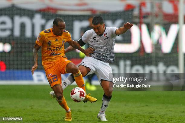 Lorenzo Reyes of Atlas fights for the ball with Luis Quiñones of Tigres during the match between Atlas and Tigres UANL as part of the friendship...