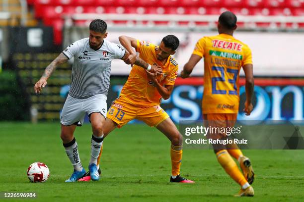 Javier Correa of Atlas fights for the ball with Diego Reyes of Tigres during the match between Atlas and Tigres UANL as part of the friendship...
