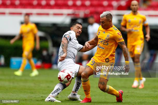 Lorenzo Reyes of Atlas fights for the ball with Jesús Dueñas of Tigres during the match between Atlas and Tigres UANL as part of the friendship...