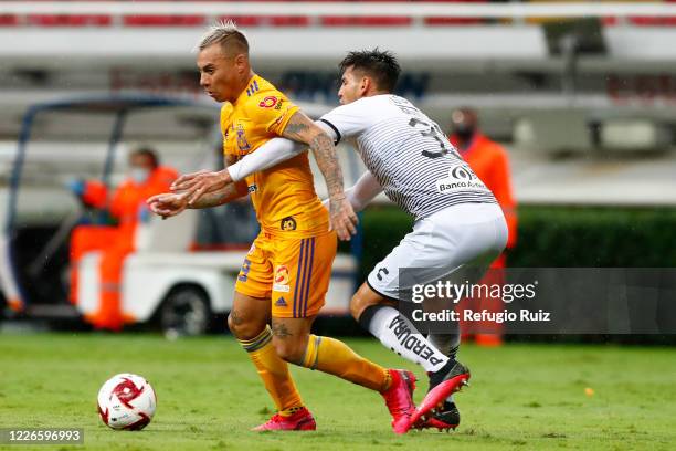 Alejandro Gomez of Atlas fights for the ball with Jesús Dueñas of Tigres during the match between Atlas and Tigres UANL as part of the friendship...