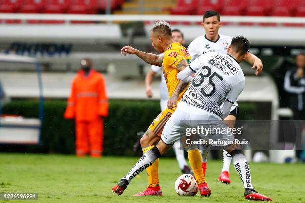 Alejandro Gomez of Atlas fights for the ball with Jesús Dueñas of Tigres during the match between Atlas and Tigres UANL as part of the friendship...