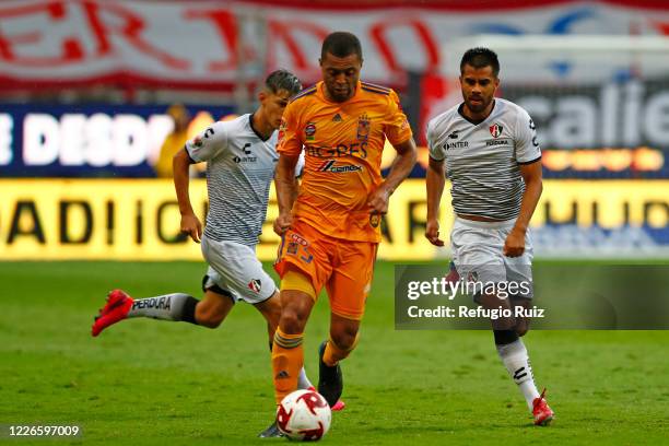 Edyairth Ortega of Atlas fights for the ball with Rafael de Souza of Tigres during the match between Atlas and Tigres UANL as part of the friendship...