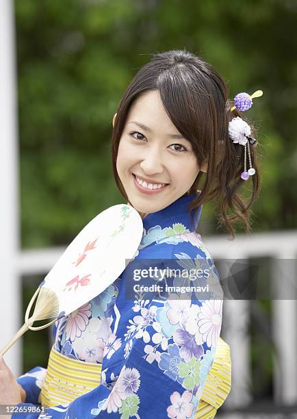 smiling young woman - hand fan stock pictures, royalty-free photos & images