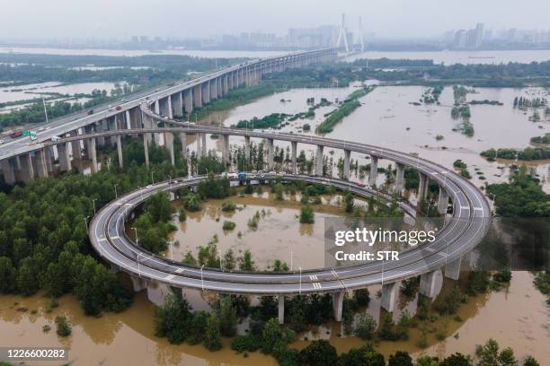 This aerial view shows a bridge leading to the inundated Tianxingzhou island, which is set to be a flood flowing zone to relieve pressure from the...