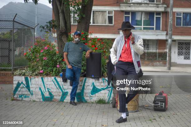 Stiven Castro, a Michael Jackson Impersonator, performs in front of residential buildings to survive the recession caused by the novel Coronavirus...