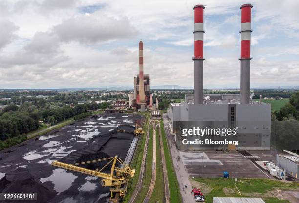 The Verbund AG combined cycle gas turbine power plant, right, stands alongside the site of Austrias last coal-fired power station in this aerial...