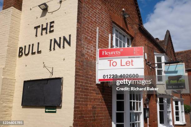 An estate agent's sign outside the Bull Inn, a property in the village of wool town Cavendish, on 10th July 2020, in Lavenham, Suffolk, England....