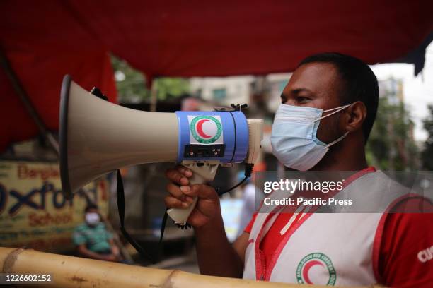 Red crescent volunteer is telling people to stay inside home during the COVID-19 pandemic.