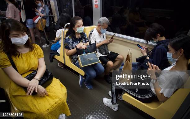 Passengers travelling on the Wenhu Line of the MRT underground are masking whilst in the tightened compartment of an unmanned train, amid the spread...