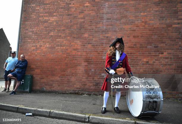 Band member dressed as King William of Orange watches on as loyalist and protestant band members take part in a socially distanced Twelfth parade on...