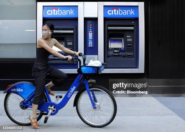 Cyclist wearing a protective mask rides past a Citigroup Inc. Citibank bank branch in New York, U.S., on Thursday, July 9, 2020. Citigroup is...