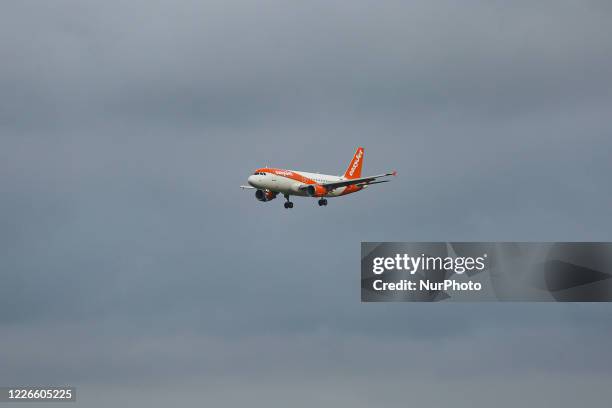 EasyJet Europe low cost airline Airbus A320 aircraft as seen on final approach on final flying, touch down, landing and breaking phase at Amsterdam...